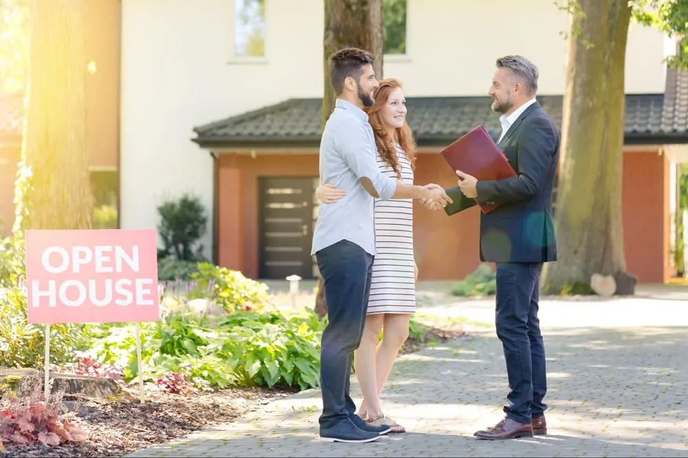 a couple talking to a real estate agent