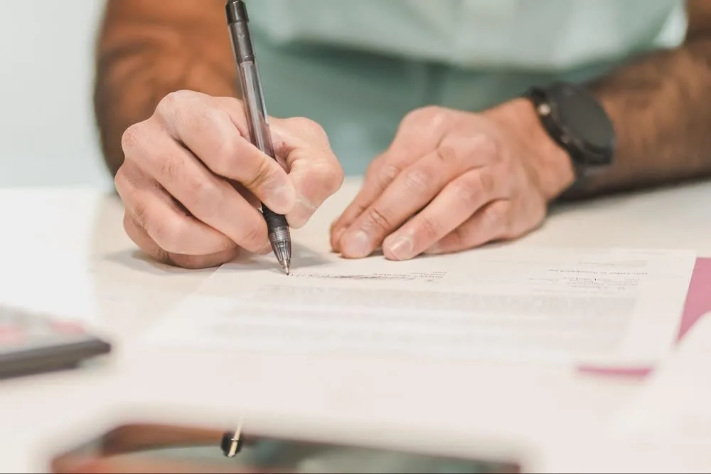 Close up on some one signing a contract